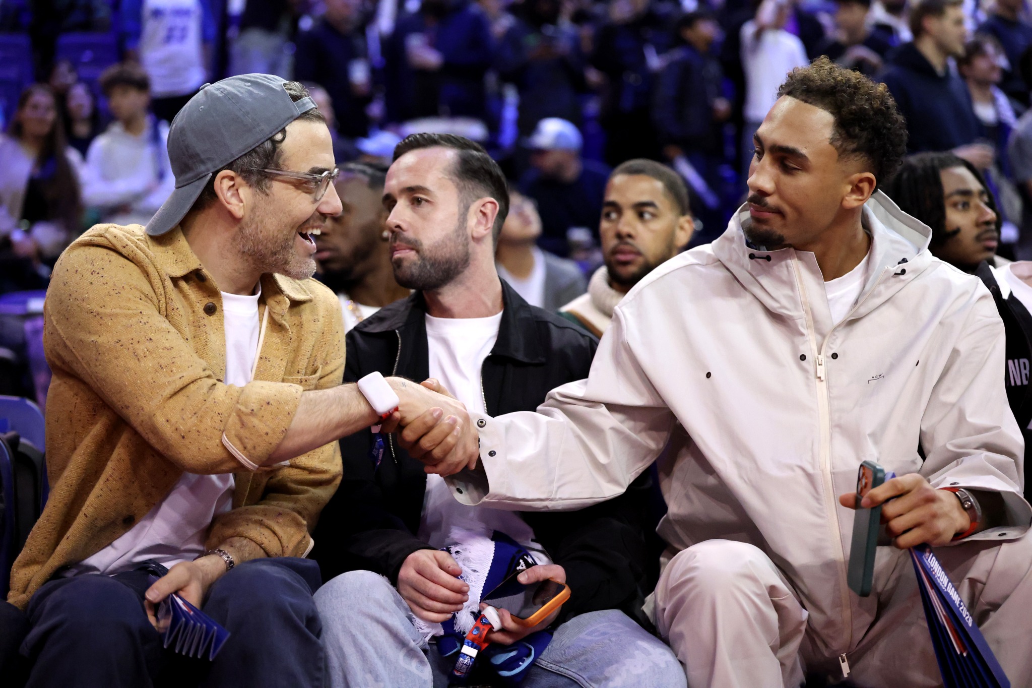 Jordan Foster speaking with an athlete courtside