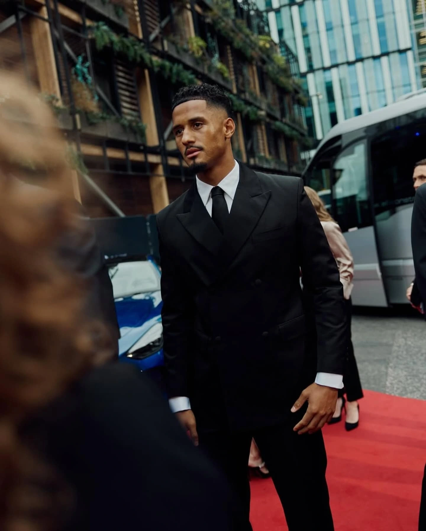 William Saliba in a black suit on the red carpet